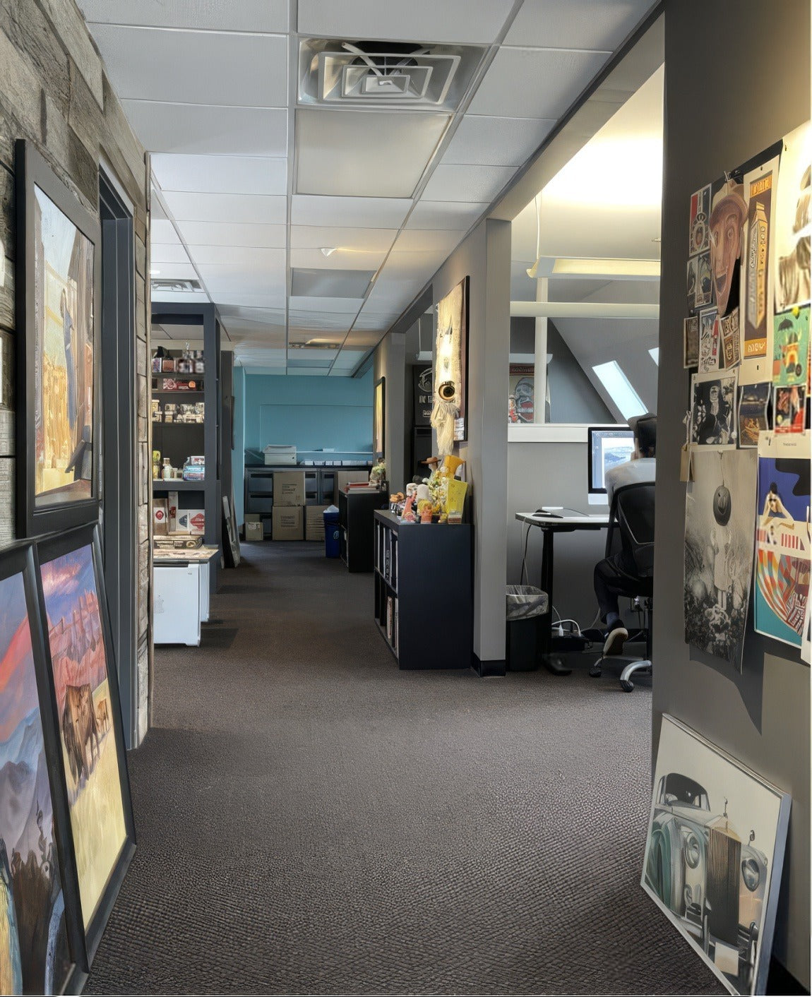 A hallway in the ADG studio lined with framed posters